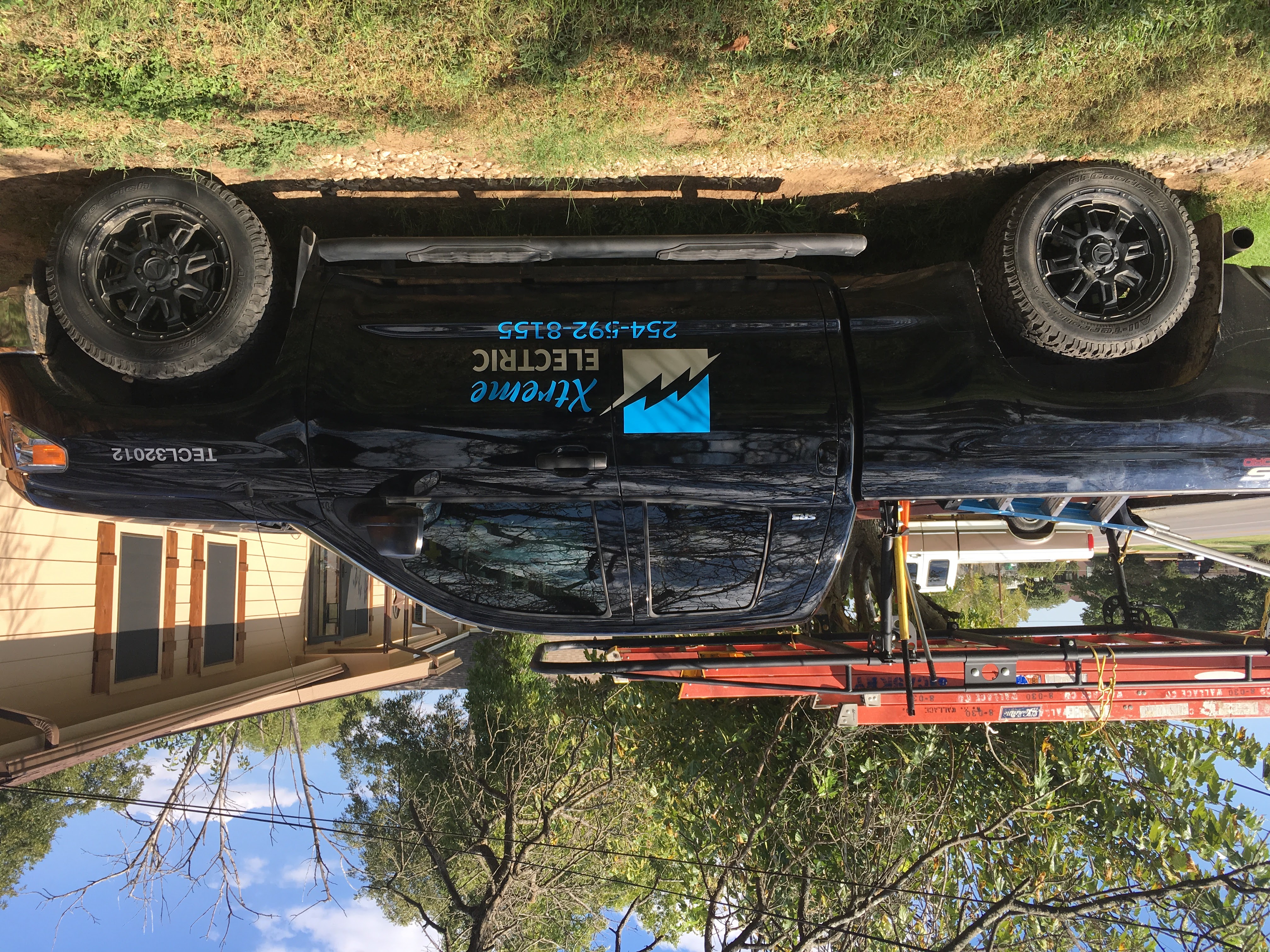 Xtreme Electric service truck with ladder rack parked at a residential job site in Stephenville, TX, licensed electrician TECL32012